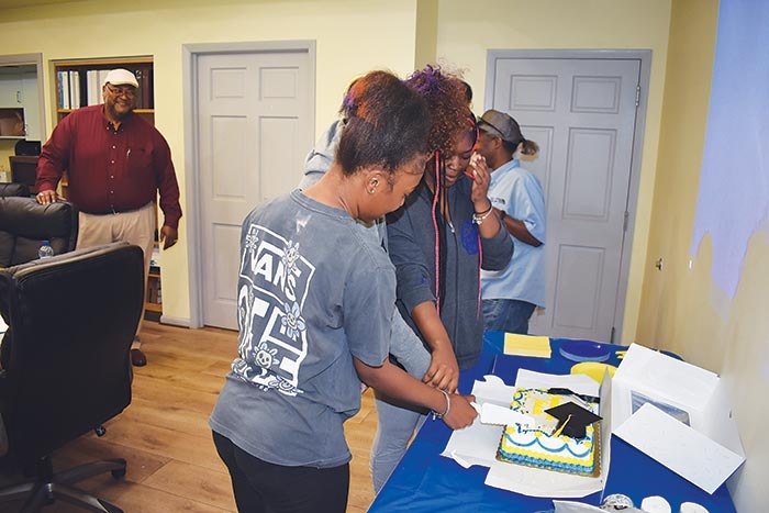 Graduates cutting cake